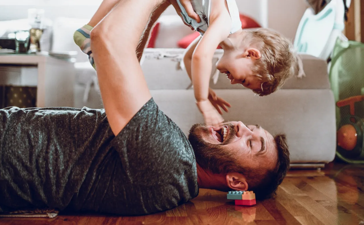 Father and child laying on floor happy with new floors