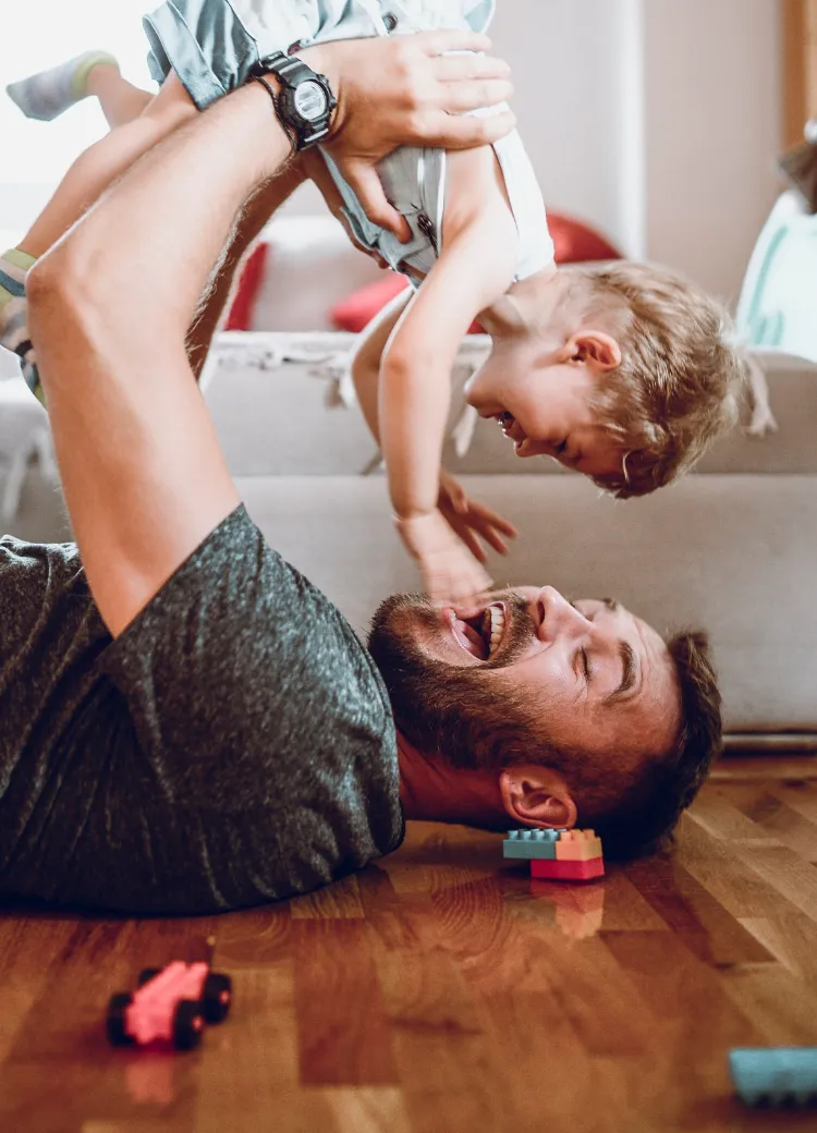 Father and child laying on floor happy with new floors